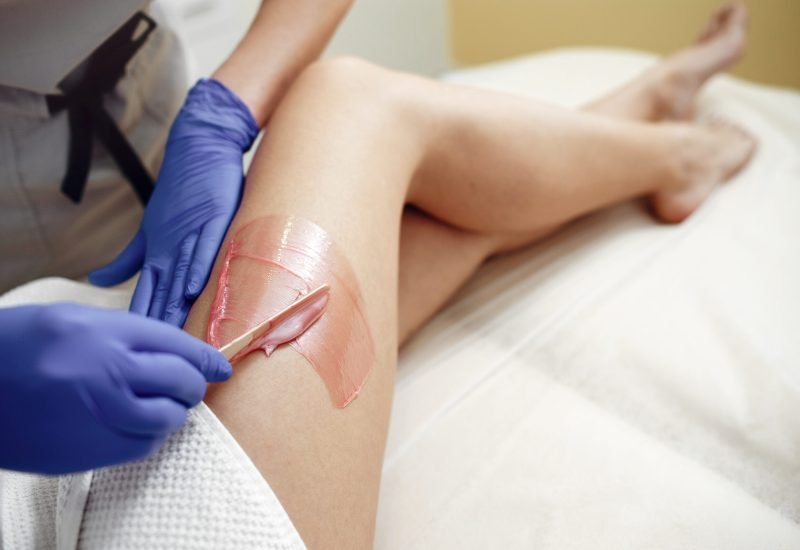 beautiful young girl in beauty salon Beautiful girl doing hair removal. Woman in beauty salon