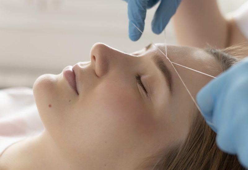 close-up-young-woman-getting-eyebrow-treatment close-up-young-woman-getting-eyebrow-treatment